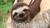 a sloth is being held by a woman with the words love you bunches written on the bottom