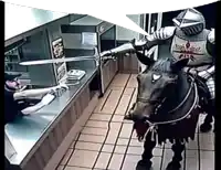 a man in armor riding a horse in a restaurant