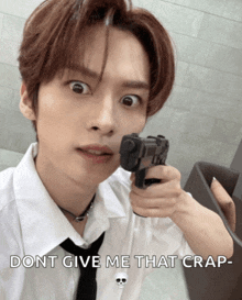 a man in a white shirt and tie is pointing a gun with the caption " dont give me that crap " below him