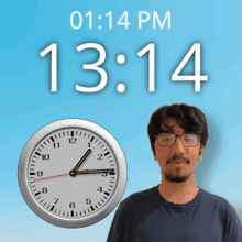 a man with glasses stands in front of a wall clock that says 13:14