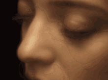 a close up of a woman 's face with closed eyes