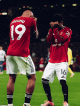 two soccer players one of whom has the number 19 on their jersey