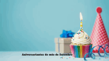 a birthday cupcake with a candle and the words " aniversariantes do mes de setembro " below it