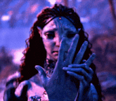 a close up of a woman 's face with a hand covering it