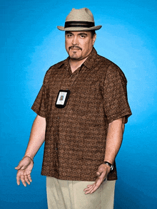 a man wearing a hat and a lanyard with a name tag that says ' inspector ' on it