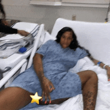 a woman is laying in a hospital bed with a star on her leg .