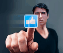 a man is pointing at a blue square with a thumbs up on it