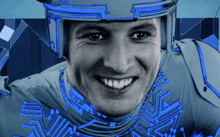 a man wearing a helmet and a blue shirt smiles