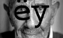 a black and white photo of a man with the word ey on his face