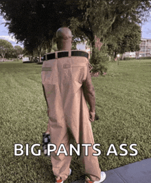 a man in big pants walking down a sidewalk