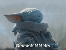a baby yoda from the mandalorian is sleeping with his eyes closed and the words ommmmmmmm written on the bottom .