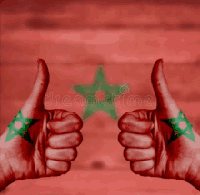 two hands painted with the flag of morocco are giving a thumbs up sign