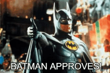 batman is giving a thumbs up sign in a movie .