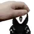 a person is petting a stuffed animal with a white eye on it .