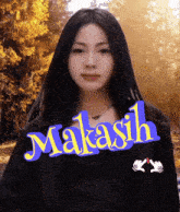 a woman with long black hair is standing in front of a sign that says " makash "