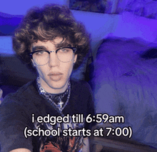 a young man wearing glasses and a black shirt with the words i edged till 6:59am ( school starts at 7:00 )