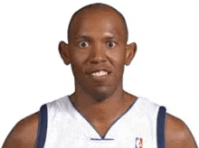 a basketball player with big ears is smiling and looking at the camera .