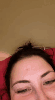 a woman with a red spot on her forehead