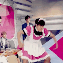 a man in a maid dress is dancing in a room