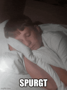 a young boy is sleeping in a bed with the word spurgt above his head