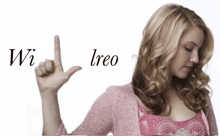 a woman in a pink top is making a hand gesture with the letters wi and ireo written in the background