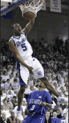 a basketball player wearing a drake jersey is jumping in the air