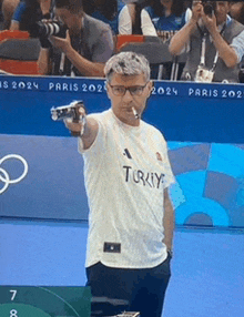 a man wearing a white shirt that says turkey is holding a camera