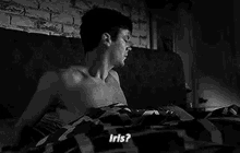 a black and white photo of a shirtless man laying in bed talking to iris .