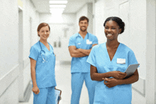 a group of doctors and nurses are standing in a hallway smiling