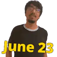 a man wearing glasses and a black shirt points to the date june 23