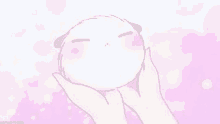 a person is holding a white ball in their hands with a pink background .