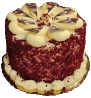 a red velvet cake with white frosting and chocolate on top