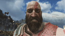 a bald man with a beard is wearing a red shirt