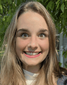 a close up of a woman 's face with a slight smile on her face