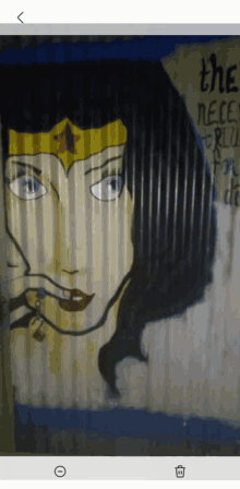 a painting of wonder woman on a wall with the words " they need freedom for do "