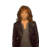 a woman with red hair is wearing a black jacket