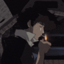 a man is smoking a cigarette in a dark room .