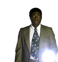 a man in a suit and tie holds a flashlight in his hand