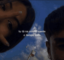 a man and a woman are looking at the camera with the words tu ta na minha mente o tempo todo above them