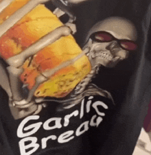 a skeleton holding a piece of garlic bread