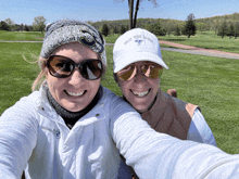 two women are posing for a picture with one wearing a white hat that says eaglebrook