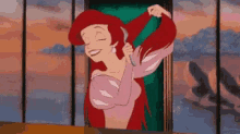 a cartoon of ariel from the little mermaid brushing her hair with a comb .