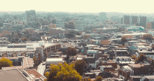 an aerial view of a city with a few buildings including one that says ' lg ' on the top of it