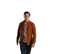 a man in an orange shirt is standing in front of a white backdrop