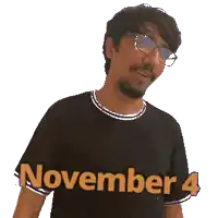 a man wearing glasses and a black shirt with november 4 written on it