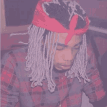 a man with dreadlocks and a bandana on his head