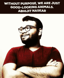 a man wearing glasses and a red shirt with a quote from abhijit naskar