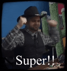 a man wearing a cowboy hat is standing in front of a cactus and a sign that says `` super '' .