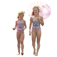 a woman and a little girl in matching swimsuits are walking