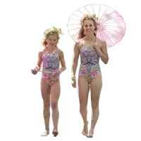 a woman and a little girl in matching swimsuits are walking